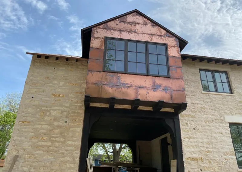 Copper metal panel facade on a stone building for Skylight Installation in Santa Fe Springs
