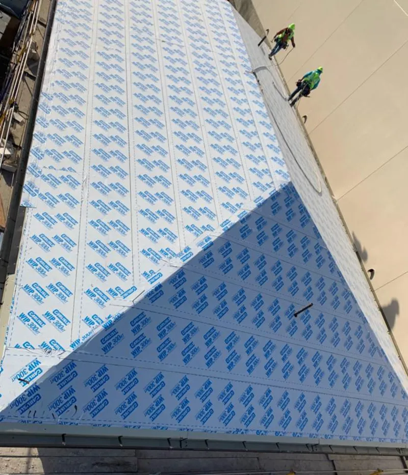 Professional roofers installing underlayment on a metal roof in Santa Fe Springs